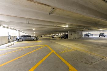 a parking garage with cars parked in it at Pinnacle Apartments, Jacksonville, FL